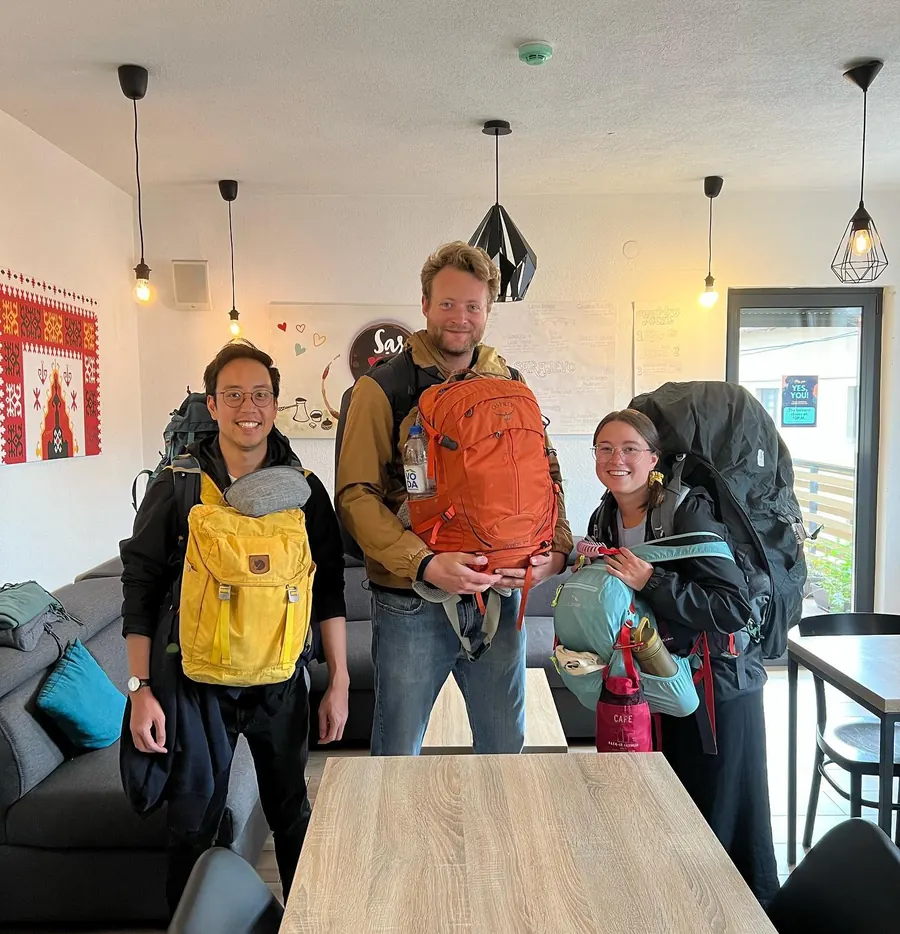 Three guests with their backpacks, just arrived in our common room