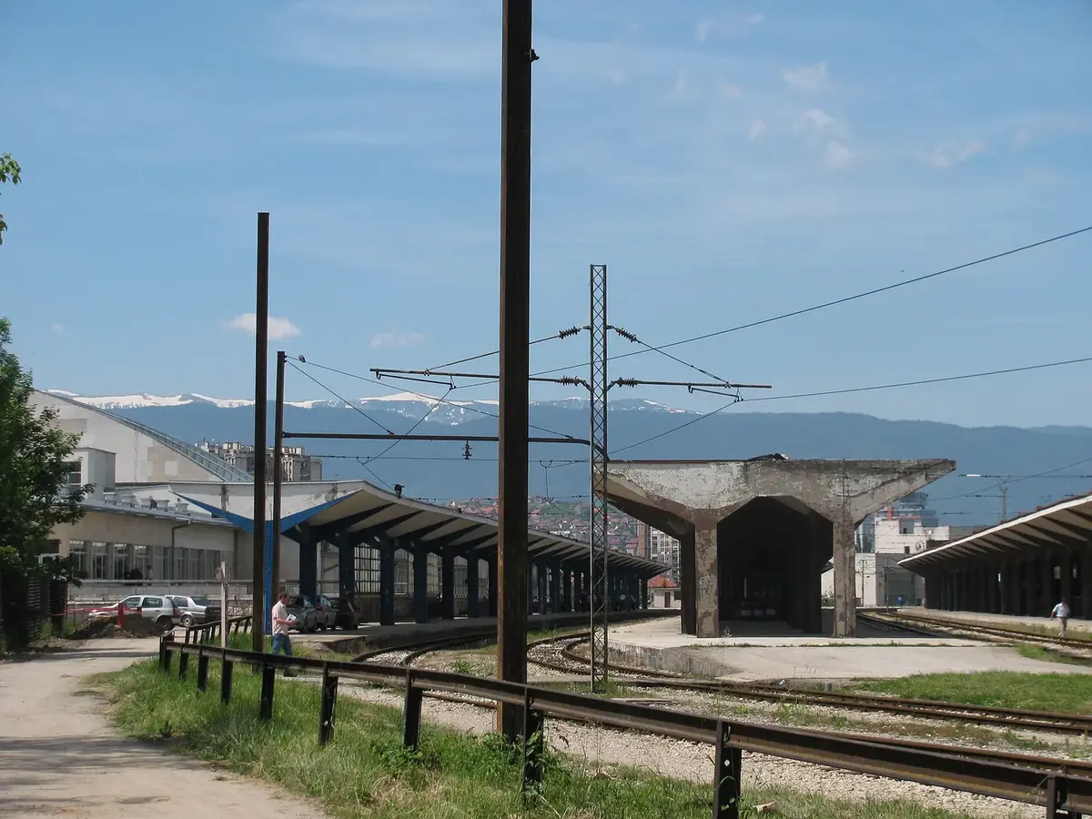 Platforms and tracks at Sarajevo railway station with snow on the mountains behind