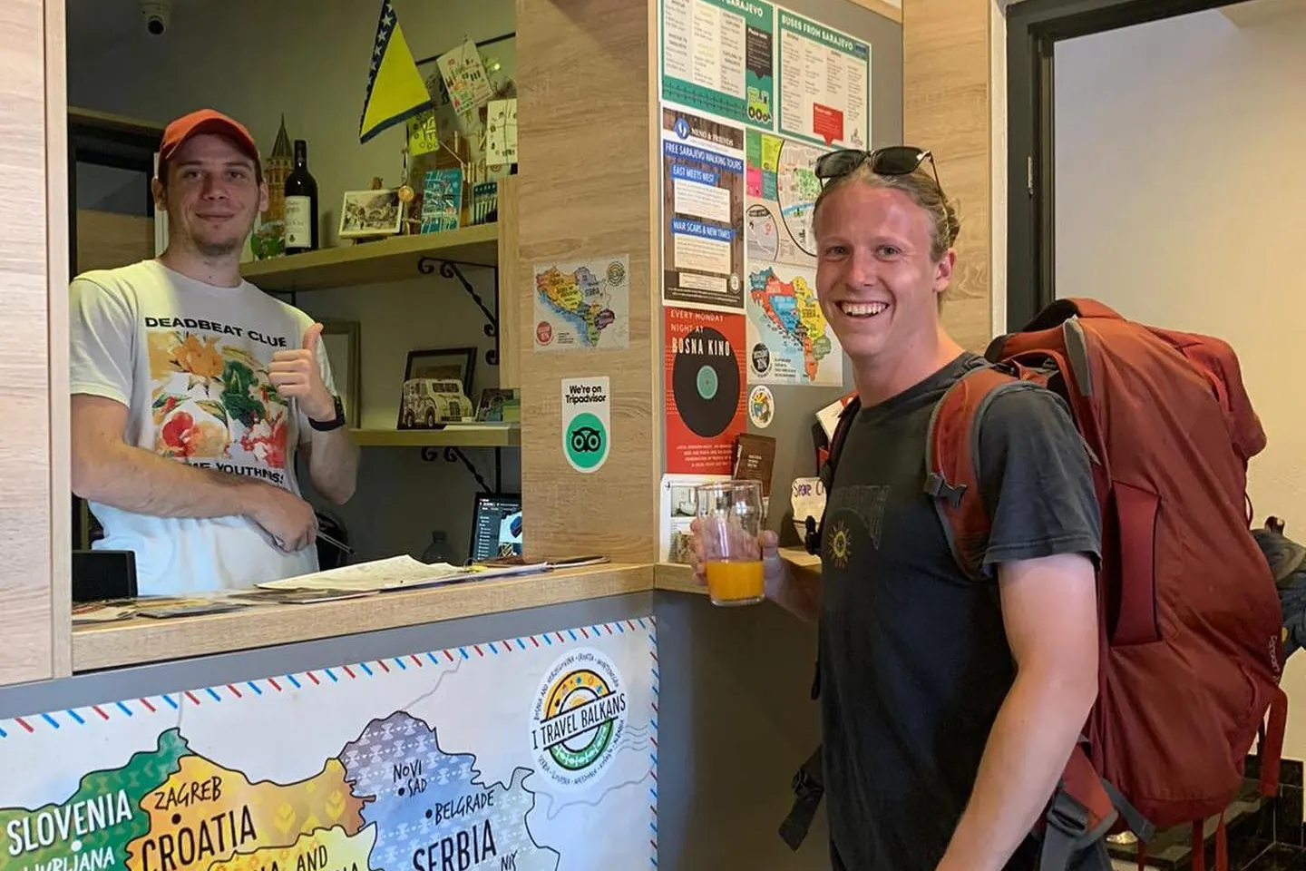 A guest with his backpack at the reception desk
