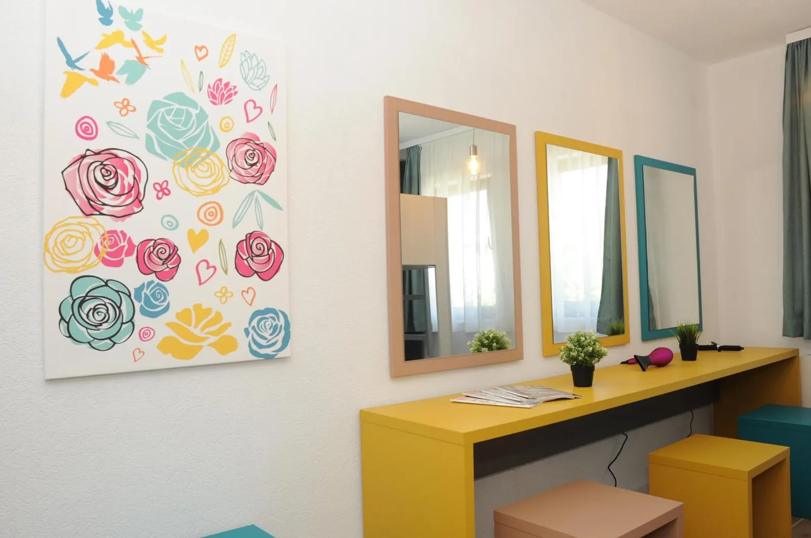 The yellow dressing table and three mirrors in the Ruže dorm