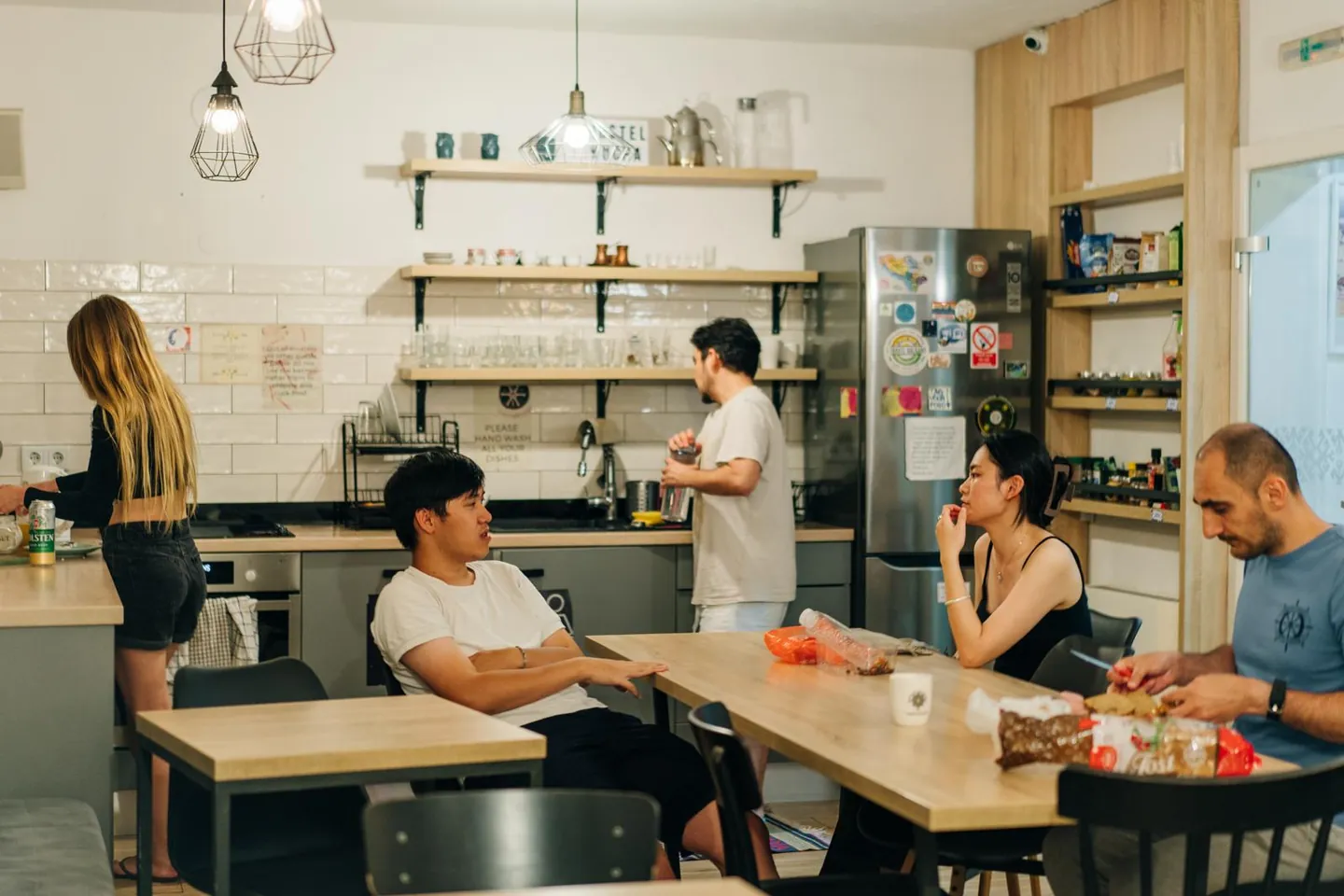 Guests chatting at the tables in our kitchen