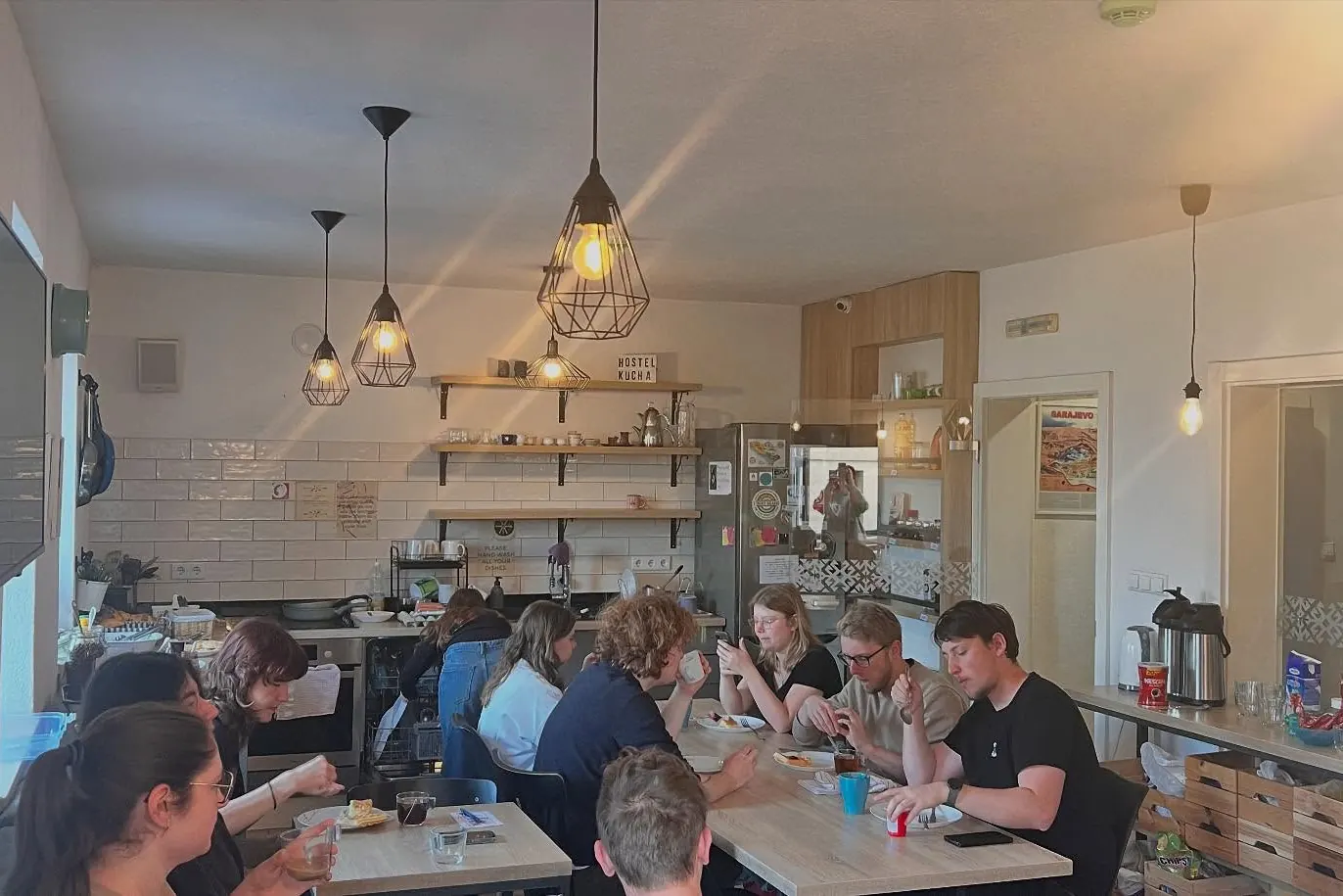 Guests talking round the tables in our common room
