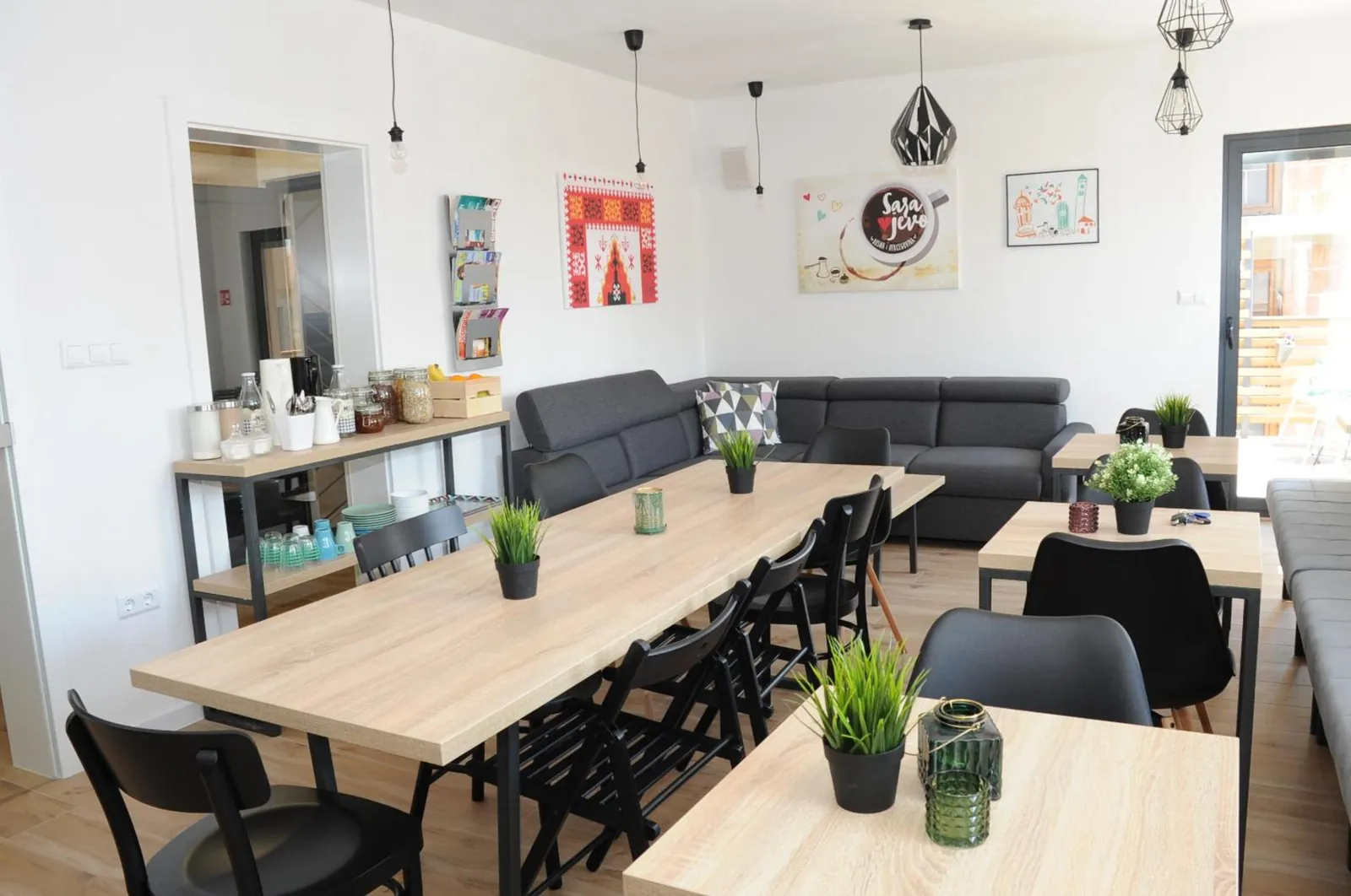 Long tables, plants and sofas in our common room