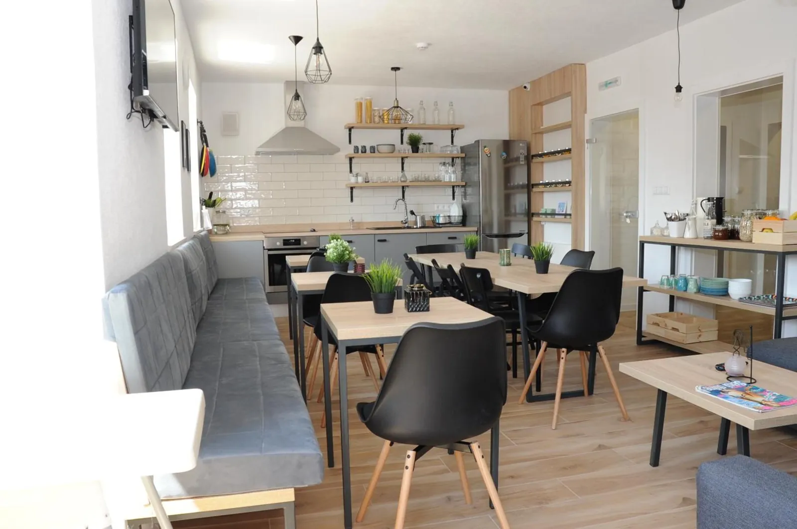 Tables and a long bench by the kitchen