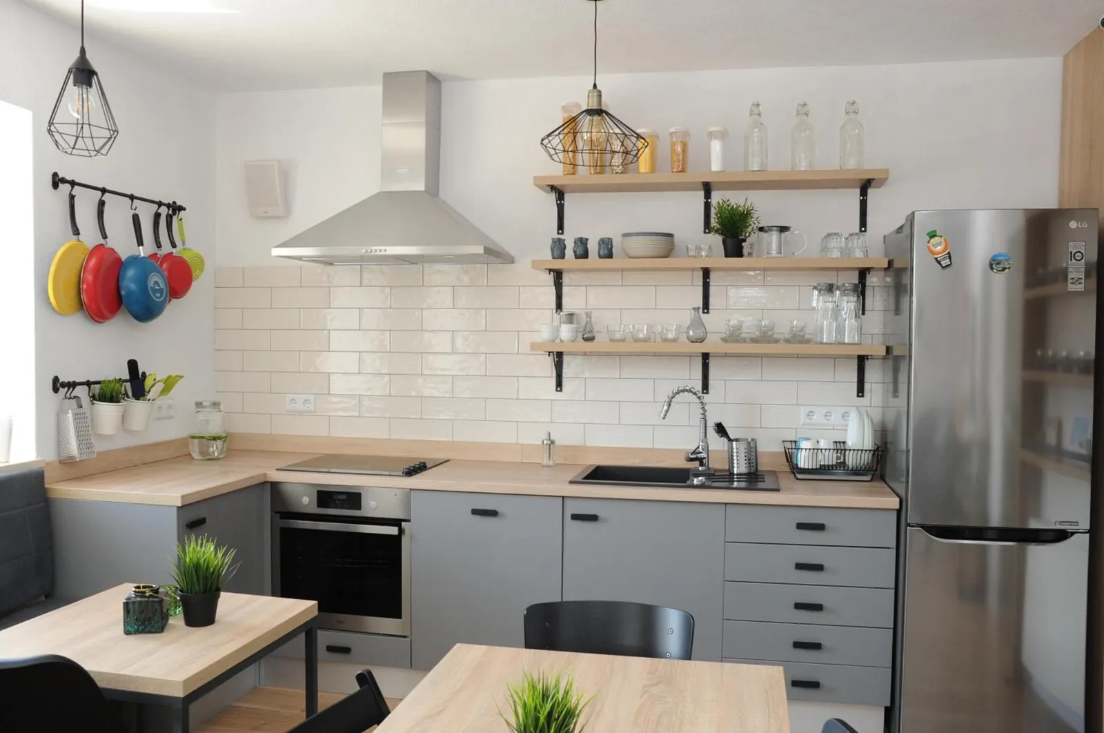 Our kitchen, with an oven, a big fridge and open shelves