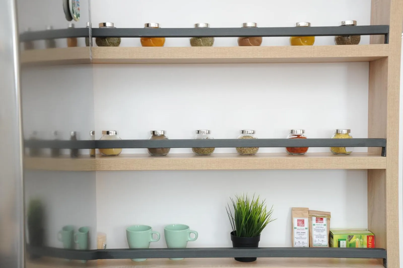 Mugs, tea and spices on our kitchen shelves
