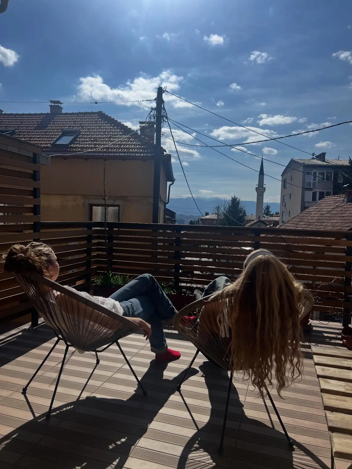 Two guests relaxing in the sun on our terrace